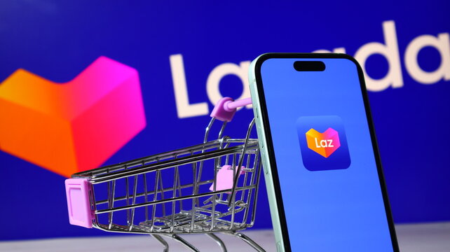 Modern smartphone featuring Lazada ecommerce app logo beside miniature retail shopping cart.