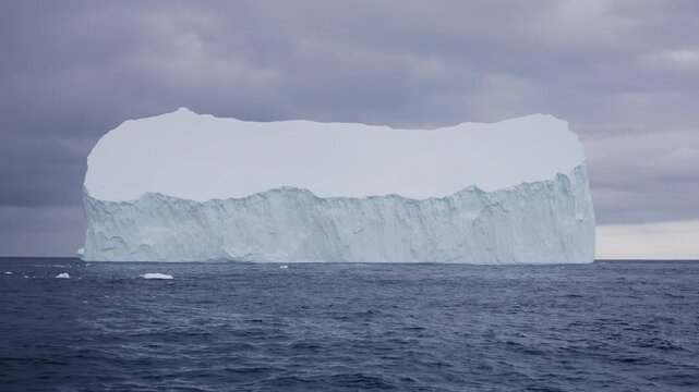 Massive tabular iceberg floating in open ocean