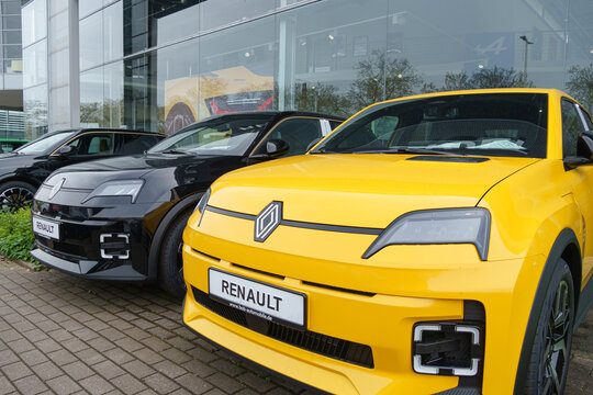 Dusseldorf, Germany - April 12 2026: Two new Renault 5 electric cars parked in front of a dealership building in Dusseldorf