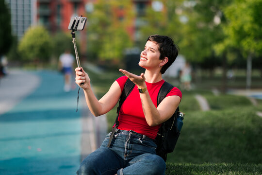 Woman creating social media content with smartphone outdoors