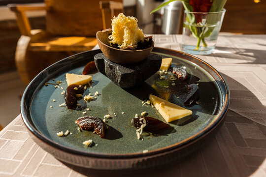 Gourmet presentation of traditional Ecuadorian figs with cheese dessert served on a ceramic plate
