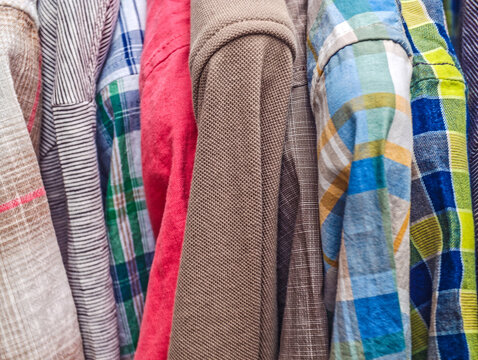Clothing rack displaying various shirts and vibrant patterns