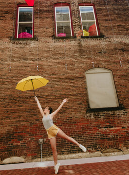Girl holding yellow umbrella
