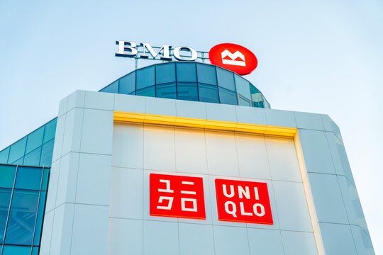 Toronto, Canada - Jun 27, 2026: Exterior view of a global apparel & lifestyle retailer UNIQLO and BMO Bank of Montreal (UNIQLO 2,400+ locations worldwide and BMO 1,200+ branches)