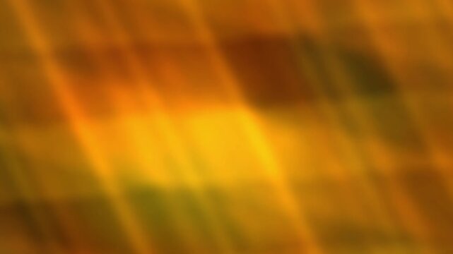 Blurred plaid background featuring seamless looping texture in warm orange and yellow hues