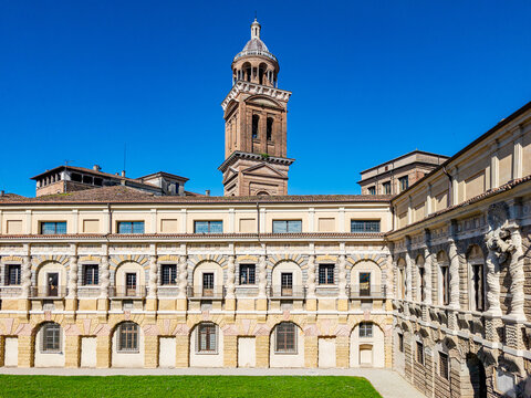 Ducal Palace features rusticating architecture and ornate details, showcasing historical grandeur and Renaissance design under a clear blue sky, with a towering campanile in the background
