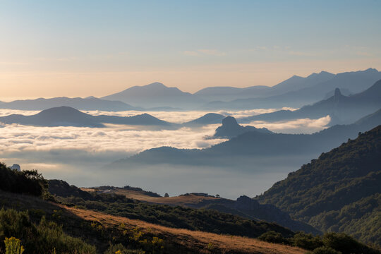 View of the mist-shrouded valleys and mountains of the Picos de Europa from the Collado de Llesba viewpoint, Cantabria, Spain