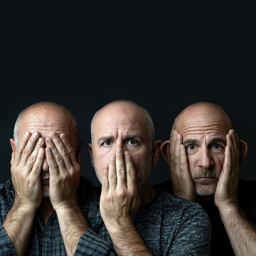 Three Bald Men Depicting See No Evil, Hear No Evil, Speak No Evil, Against a Black Background, Symbolizing Silence, Moral Avoidance, Ethics, and Human Emotion. Copy Space.