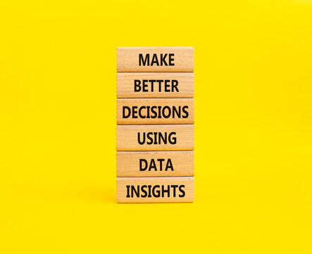 Make better decisions using data insights symbol. Concept words make better decisions using data insights on wooden blocks. Beautiful yellow background. Business concept. Copy space.