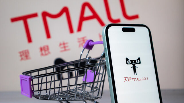 Tmall shopping concept with miniature cart and smartphone screen display.