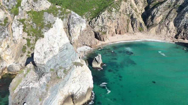 Close Drone Orbit Around the Iconic Cliffs at Praia da Ursa, Portugal