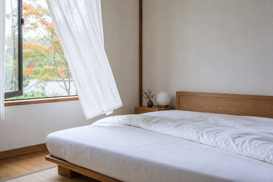 秋の朝に窓を開けて白い掛け布団を換気する明るい寝室