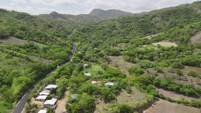 Asphalt road in green mountain hills landscape aerial drone view