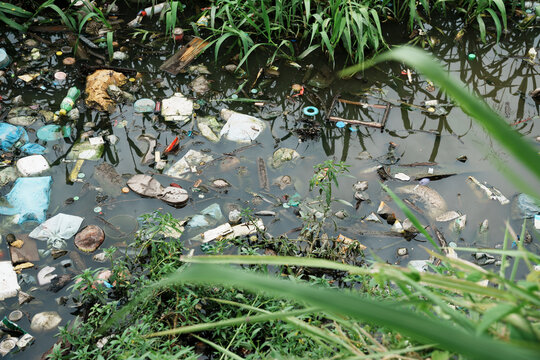 Water pollution with plastic waste and garbage flowing in canal