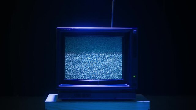 Retro TV, vintage television In a nostalgic setup, a retro TV displays grain on screen, scary halloween night device good for chroma key and green screen