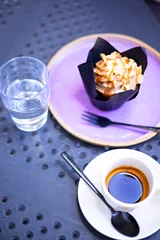 Espresso coffee served with caramel cupcake at an outdoor café © Alejandro