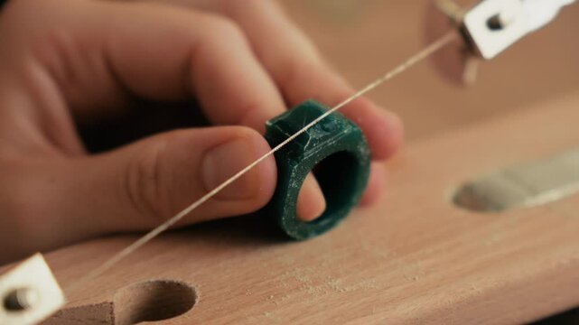Static Macro Video of Jeweler Cutting Green Wax Signet Ring with Piercing Saw on Bench Pin