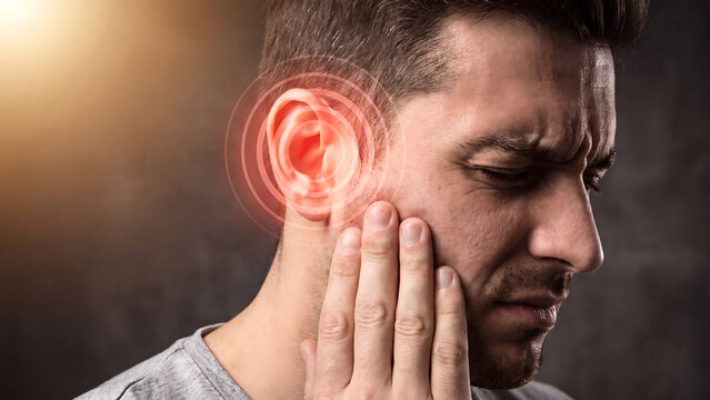 Man with ear pain highlighted in red touching sore ear representing earache and infection discomfort