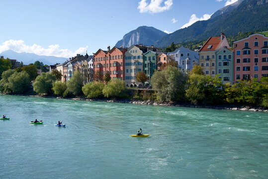 Travel Photography of Kayakers on Inn River with Colorful Houses Innsbruck Austria