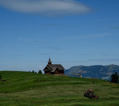 Traditional wooden chapel on green alpine meadow in Stoos, Switzerland