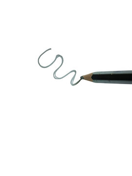 Wooden pencil drawing a wavy line on a sheet