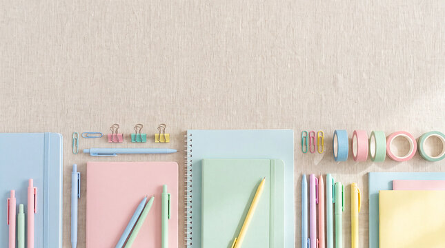 Pastel school and office supplies on a fabric background