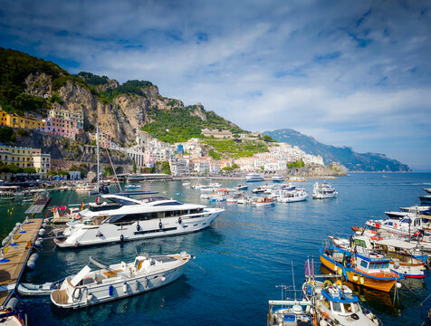 07 21 2026 - Amalfi, Italy. Amalfi Coast and harbor with luxury yachts on a sunny day at port, stunning Mediterranean coastline and scenic seaside landscape in Amalfi, Italy
