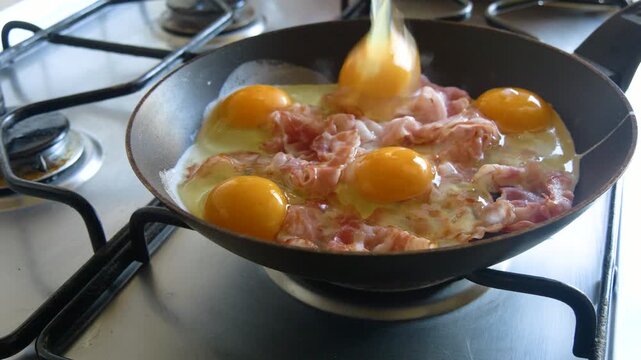 Classic breakfast cooking with eggs and bacon