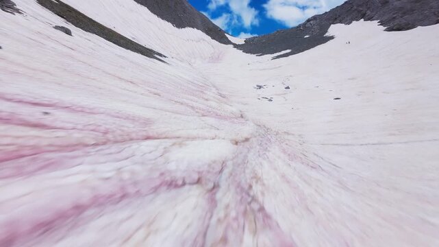 High speed FPV drone shot diving along snow covered mountain slope in Greece