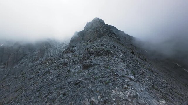 Dynamic FPV drone shot climbing along sharp crest of Mount Olympus Greece