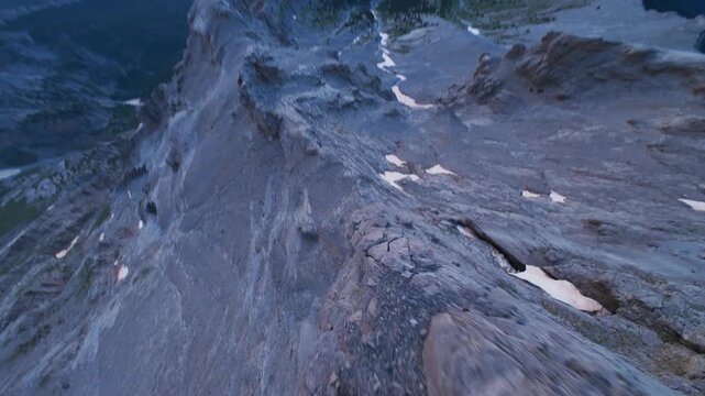 Dynamic FPV drone shot diving along sharp crest of Mount Olympus Greece
