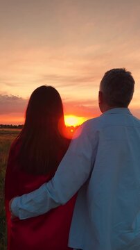 man woman hugging watching sunset, people love hugging sunset, happy family, Sunset Companions, Together in Nature, Field of Dreams Couple, Sun-kissed Romance, Intimate Sunset Moment, Lovers in the