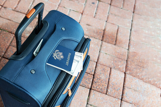 Suitcase With United States Passport And Dollar Bills Ready For International Travel