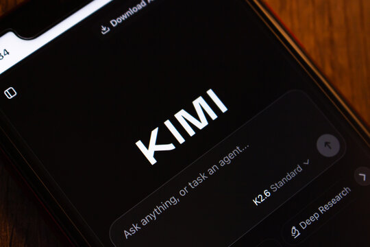 Mexico City, MEXICO - Jul 21 2026 : Smartphone on a dark wooden surface displaying the Kimi AI assistant app by Moonshot AI, with the K2.6 model selected and a Deep Research option visible.