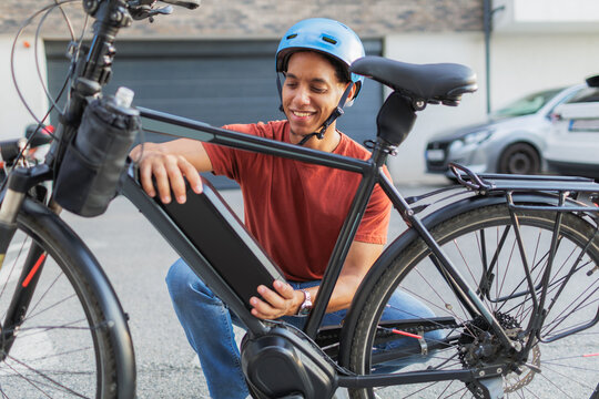 Man changing battery on his electric bicycle