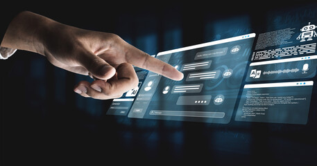 Fototapeta premium A human hand interacts with a virtual touchscreen interface displaying AI chatbot features and digital communication elements, symbolizing the future of technology and innovation. Ledger