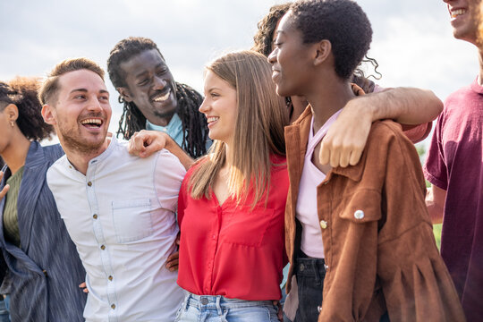 Cheerful Diverse Friends Group Embracing and Laughing Outdoors