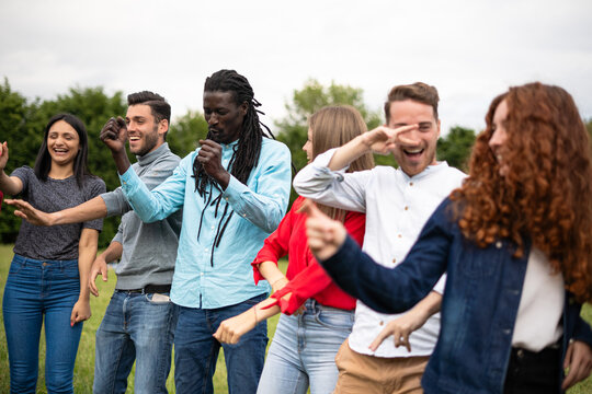 Diverse Group of Friends Dancing and Having Fun Outdoors