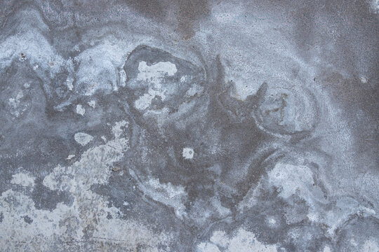 Natural mineral plaster texture with weathered cement surface, abstract gray wall background, organic construction material, distressed architectural finish with copy space