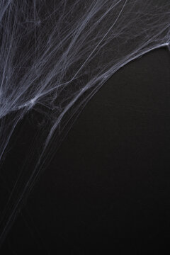 Happy Halloween spiderweb on black vertical background eerie cobweb texture for spooky decor and party designs