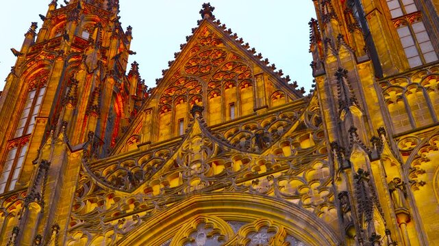 Ornate gothic facade of saint vitus cathedral in prague. Beautiful low-angle view of the intricate gothic facade of saint vitus cathedral, showcasing its famous rose window, detailed stonework