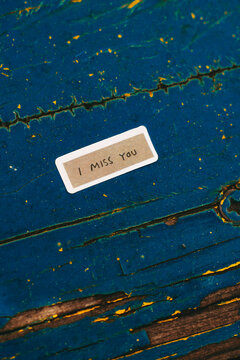 you me love message on the wooden background
Small message reading "I miss you" placed on a blue metal surface. Minimalist conceptual image symbolizing love, longing, missing someone, emotional connec