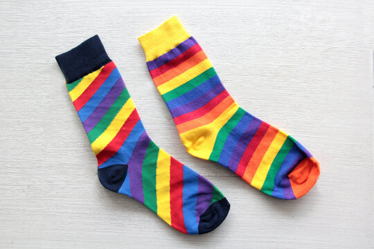 Colorful, mismatched socks ready to be worn as a symbol of inclusion, diversity, and acceptance to promote respect for people with Down syndrome