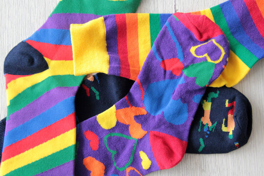 Colorful, mismatched socks ready to be worn as a symbol of inclusion, diversity, and acceptance to promote respect for people with Down syndrome