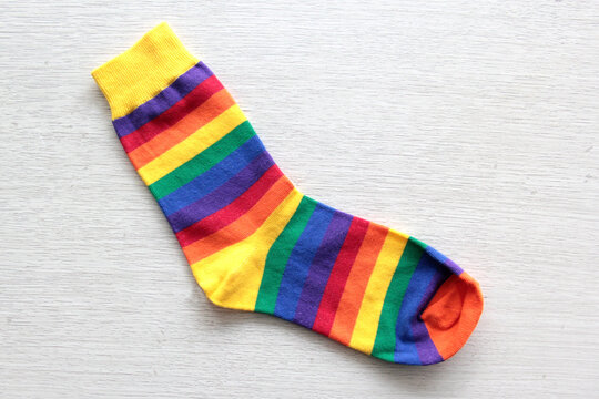 Colorful, mismatched socks ready to be worn as a symbol of inclusion, diversity, and acceptance to promote respect for people with Down syndrome