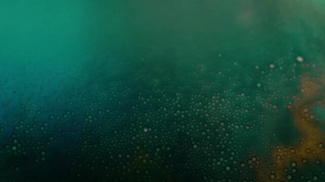 Dynamic colored liquid with bubbles as abstract background. High quality 4k footage
