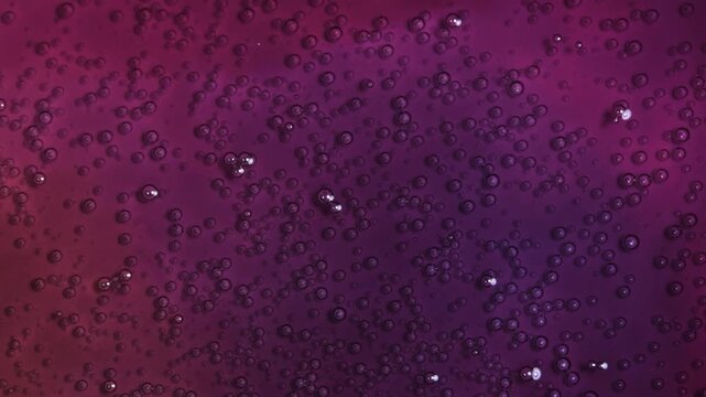 Flowing colored liquids with bubbles in abstract motion. High quality 4k footage