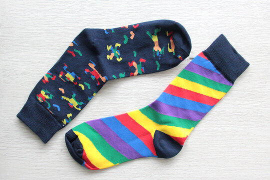 Colorful, mismatched socks ready to be worn as a symbol of inclusion, diversity, and acceptance to promote respect for people with Down syndrome