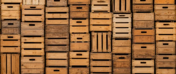 Empty fruit boxes stacked on top of each other. A seamless wall of rustic, stacked wooden crates creating a textured pattern. © juanorihuela