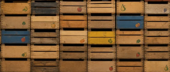 A seamless wall of rustic, stacked wooden crates creating a textured pattern. Empty fruit boxes stacked on top of each other © juanorihuela
